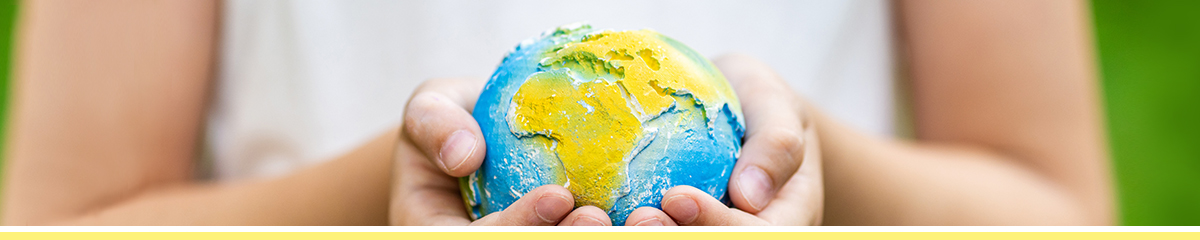 Hands gently hold globe, symbolizing environmental care.