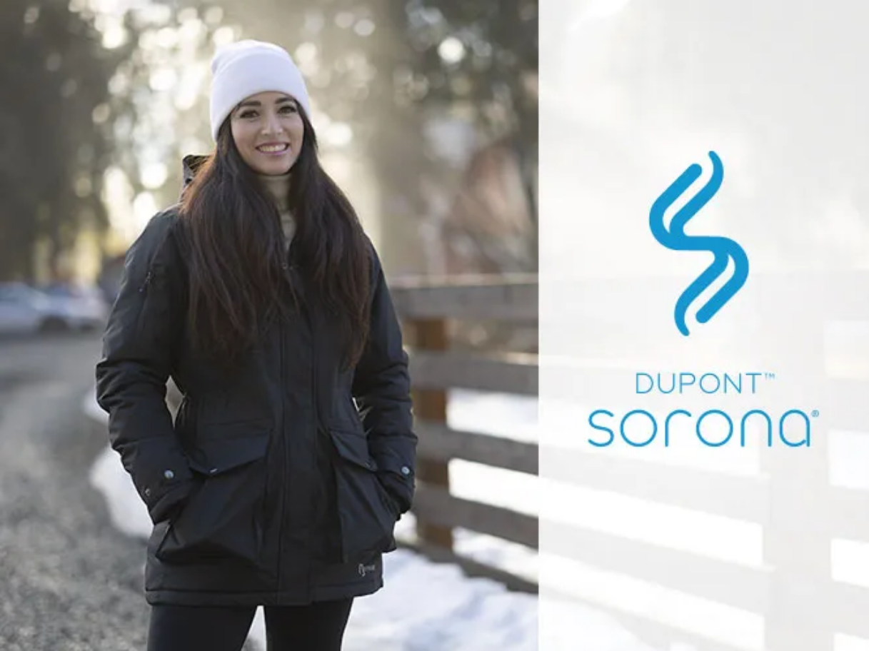 Woman in winter clothes smiling, DuPont Sorona logo